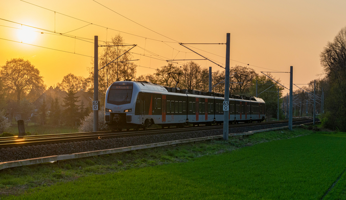 Train on rails before a sunset
